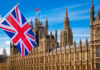 Britain’s Hardline Immigration Shift Alarms Critics British flag waving in front of the Parliament building in London
