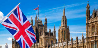 British flag waving in front of the Parliament building in London