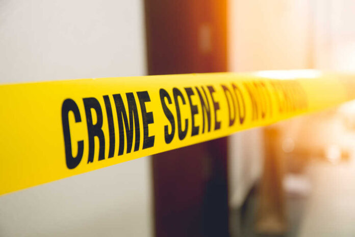 Yellow crime scene tape with the words 'CRIME SCENE DO NOT CROSS'