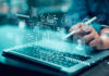 Person using stylus on laptop with AI and cybersecurity icons overlay