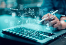 Person using stylus on laptop with AI and cybersecurity icons overlay
