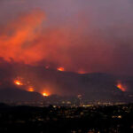 Wildfire Blamestorm—But Where Are The Logs? Wildfire lighting up the night sky over hills