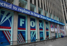 Fox News building exterior with ticker and barricades