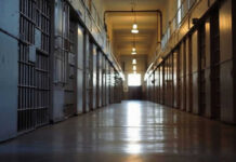Serial Killer Freed Twice—Guess What Happened Empty prison corridor with metal cell doors visible
