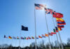 NATO Drift—China and Russia Test the Gaps Flags of multiple countries against blue sky