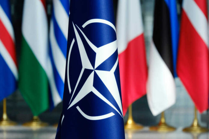 NATO flag in front of various national flags