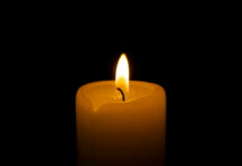Candle flame glowing in the dark