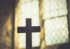 FBI Fires Analysts Behind Catholic Extremism Memo Silhouette of a wooden cross against a softly lit background