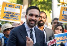 Mayor’s Monsters Rhetoric Ignites Antisemitism Firestorm A man speaking at a rally with supporters holding protest signs