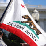 Shaky Polls Jolt California Power Game California state flag being held up at an outdoor event