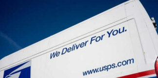 USPS delivery truck with logo and slogan visible