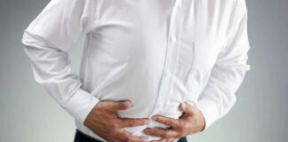 Person clutching stomach in apparent discomfort.