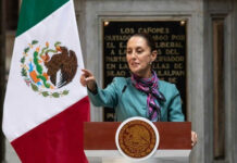 Mexico Targets ICE — U.S. Sovereignty Tested Person speaking at podium with Mexican flag nearby