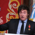 Not Superstition: Milei’s Hardline World Cup Boycott Man speaking with gestures, wearing a suit and medals.