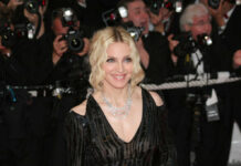 Madonna’s Bold Return Sparks Rave Reviews smiling woman on red carpet in black sequin dress