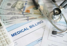 Stethoscope calculator and money on medical billing papers