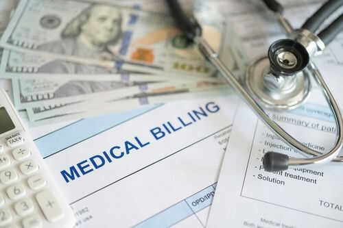 medical-billing-healthcare-cost2505543999 Stethoscope calculator and money on medical billing papers