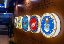 Defense Supply Chains EXPOSED — Waivers Shrink Military department seals displayed on a wall