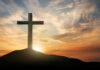 Cross on hill at sunset