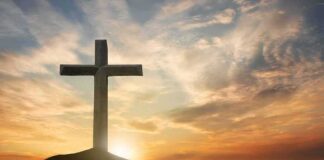Cross on hill at sunset