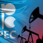 OPEC Shaken: UAE Opens the Taps OPEC logo in front of an abstract flag background with oil rigs silhouettes