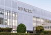 Space War Heats Up — Musk Tapped SpaceX headquarters exterior with large logo and windows