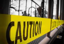Teen Terror Plots Rattle Ultra-Safe Singapore Yellow caution tape stretched across a metal playground structure