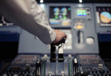 Pilot's hand operating the throttle in an aircraft cockpit