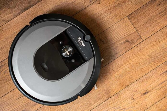 shutterstock_1972871330 robot vacuum on hardwood floor