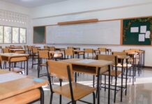 California Schools Rocked By $20M Fraud An empty classroom with wooden desks and a chalkboard