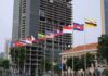 Ruling Ignored—Will ASEAN Finally Bite? Row of ASEAN national flags in front of city buildings