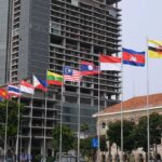 Ruling Ignored—Will ASEAN Finally Bite? Row of ASEAN national flags in front of city buildings