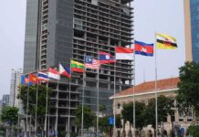 Ruling Ignored—Will ASEAN Finally Bite? Row of ASEAN national flags in front of city buildings