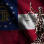 Lady Justice statue in front of Georgia state flag
