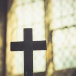 Unregistered Faith Targeted — Elders Jailed Fast Silhouette of a wooden cross against a softly lit background