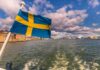 Swedish flag waving on a boat in a harbor