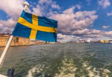 Swedish flag waving on a boat in a harbor