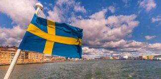 Swedish flag waving on a boat in a harbor