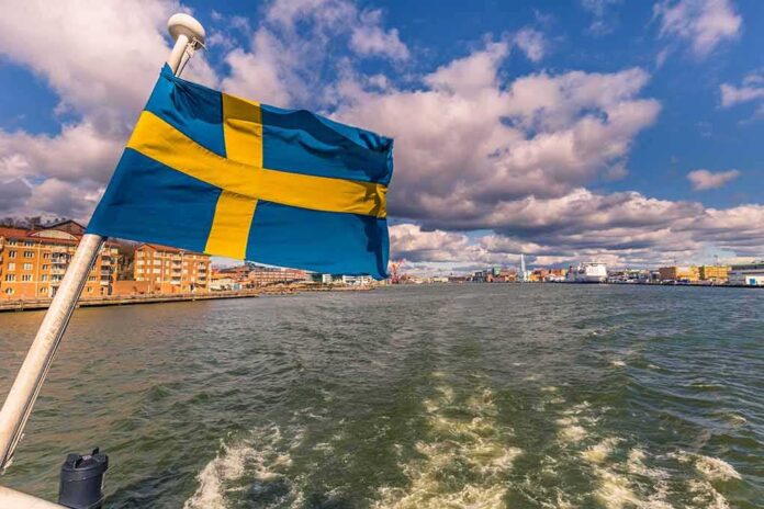 Swedish flag waving on a boat in a harbor