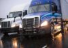 Safety Sweep Uncovers Shocking Violations Two semi trucks driving side by side on a wet highway