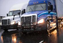 Safety Sweep Uncovers Shocking Violations Two semi trucks driving side by side on a wet highway