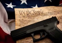 Parents Disarmed Over Daughter’s Doodle? Handgun on U.S. Constitution with American flag backdrop