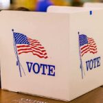 Election Shock: Michigan Targets Illegal Votes voting booth with American flag graphics