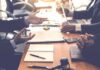 Business meeting with hands gesturing over a conference table