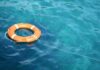 Altruism Trap: River Claims The Rescuer Orange life buoy floating on blue water