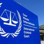 White House Moves To Cripple ICC International Criminal Court sign with scales emblem outside modern building
