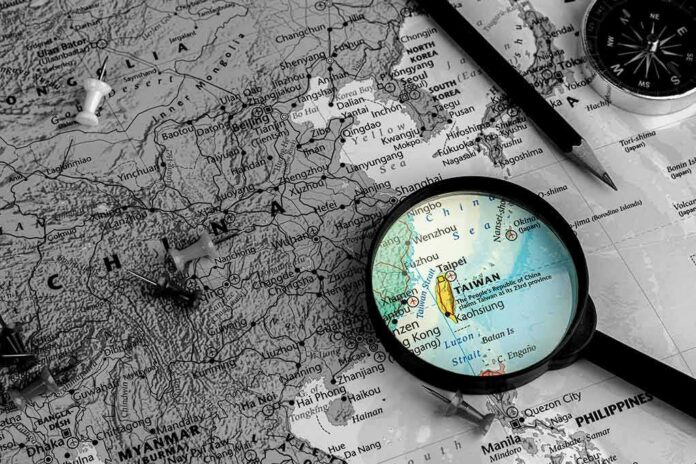 shutterstock_1531936925 Magnifying glass highlighting Taiwan on a map