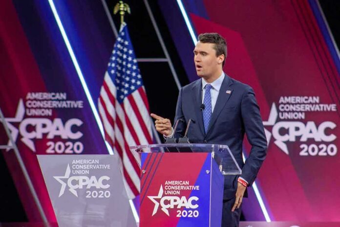 shutterstock_1683086179 Speaker in suit at CPAC podium on stage