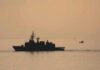 Mines Cleared—What’s Hiding Beyond The Lanes? naval ship silhouette at sea during sunset