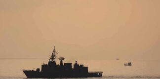 naval ship silhouette at sea during sunset